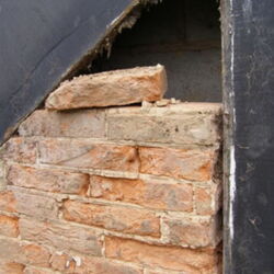 Loose brick panels prior to repair.
