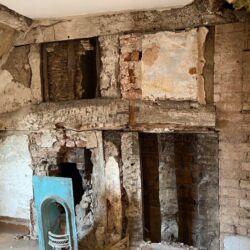 Modern plasterboard alterations had been removed to reveal the remains of the historic timber framed walling beneath. The timber frame was in good condition, some timbers showed signs of being used before, ie mortices from mortice and tenon joints. The sections of original plaster were either missing or in poor condition.