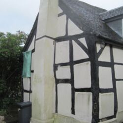 This timber framed house in the village has suffered from the use of inappropriate materials along side the historic timber frame. Heavy cement render over brick infill panels has inhibited the movement of moisture which has caused the timber to remain damp and slowly decay. The house was leaning on the end elevation from back to front which complicates the repair work. The initial plan was to remove the rotten elements and replace them with reclaimed English oak. The brick panels would not be replaced, but woodwool boards and sheepswool insulation will fill the panels which should achieve a superior U value. Then lime render and limewash will be applied to the internal and external surfaces.