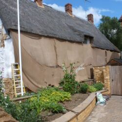Due to the hot summer weather hessian sheeting had to be erected to prevent the lime plastering rendering drying out too quickly. This also served as a shelter when applying the three coats of limewash to the wall.