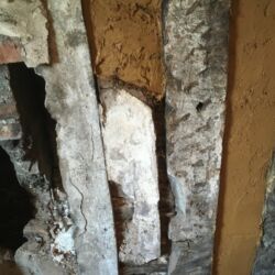 The remnants of the original lime render was conserved in place using Plaster of Paris to consolidate the edges and then clay render applied around the remains.