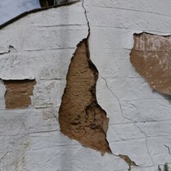 Some structural cracking was occuring in several places.
Note: chicken wire within render, peeling plastic paint and crude finish to render.
A conservation engineer surveyed the property before any lime plastering and rendering repairs were carried out.