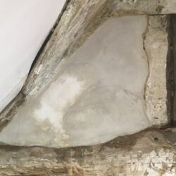 The same area replastered with lime rich top coat plaster; still drying.
