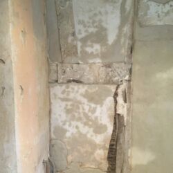 The central doorway was plastered over and the other surfaces were consolidated around the edges of the timber work. The key marks filled in with lime top coat plaster and sponged over.