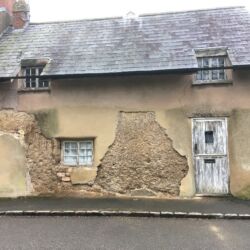 The cement based render partially removed.