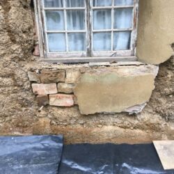 Removing the render revealed a patch of brickwork from a previous repair.