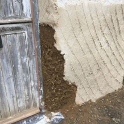 The area was repaired using cob with straw. The cob used for the repair was recycled from an adjacent repair on the house.