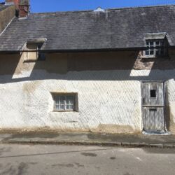 The scratch coat of lime render was applied to the front elevation of the cottage.