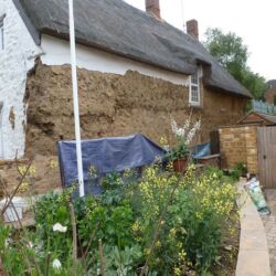 Side elevation with majority of the cement render removed.The front elevation is stonework.
