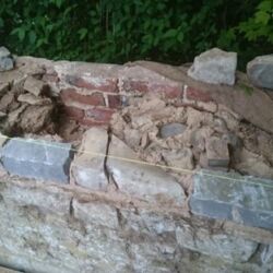 Original stones were reused together with new Lias stones. The core of the wall was filled solid with stone and lime mortar.