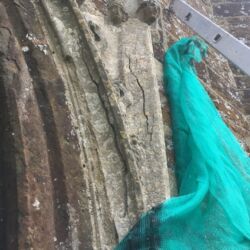 Structural cracking due to delamination and edge bedded stone.