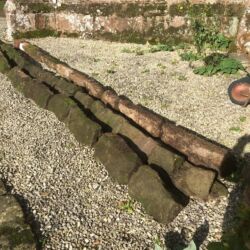 Copings were removed, numbered, and laid out for inspection to assess their suitability for reuse.