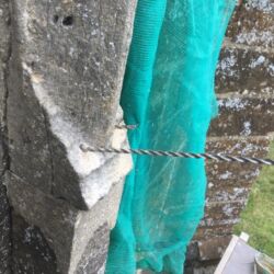 One tie is shown pulled back to demonstrate the required depth of the ties.