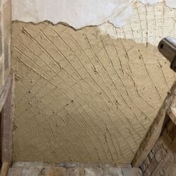 A scratch coat of plaster applied to the new oak laths.