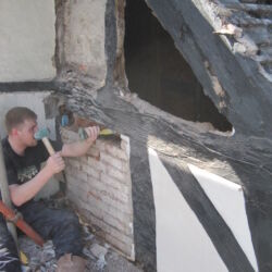 The brick panels are removed to reveal the extent of the problem.