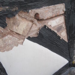 Timber had previously been taken out and replaced with bricks and fake timber created by making lines in wet mortar and blacked over!
