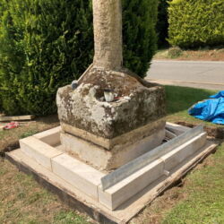 The first course of new stone set out dry bedded onto the concrete base.