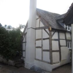 The completed work! Out of the 34 individual timbers on the end elevation of the house 29 were replaced. The chimney stack was taken down half way and rebuilt. The woodwool panels were rendered with three coats of non hyrdaulic lime render and the chimney stack was rendered with three coats of hydraulic lime render. All areas were then limewashed with a casein based limewash.