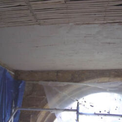 A haired lime base coat is being applied to the laths